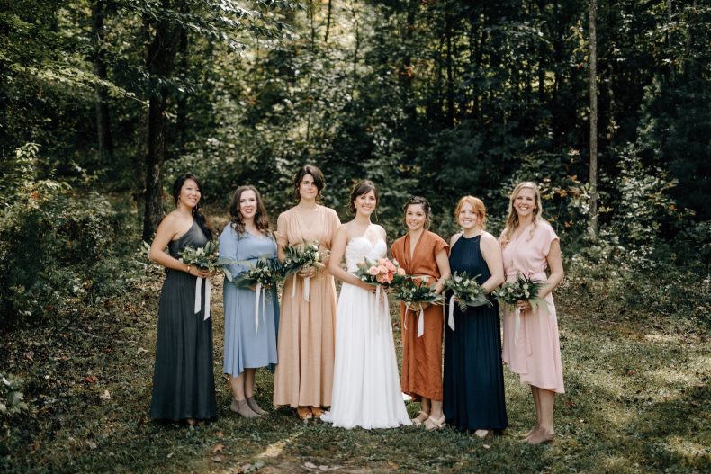 bridesmaids wearing colorful dresses at their sugarboo farms wedding in blairsville