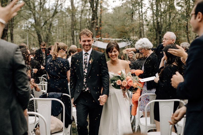 bride and groom walking through confetti at their sugarboo farms wedding